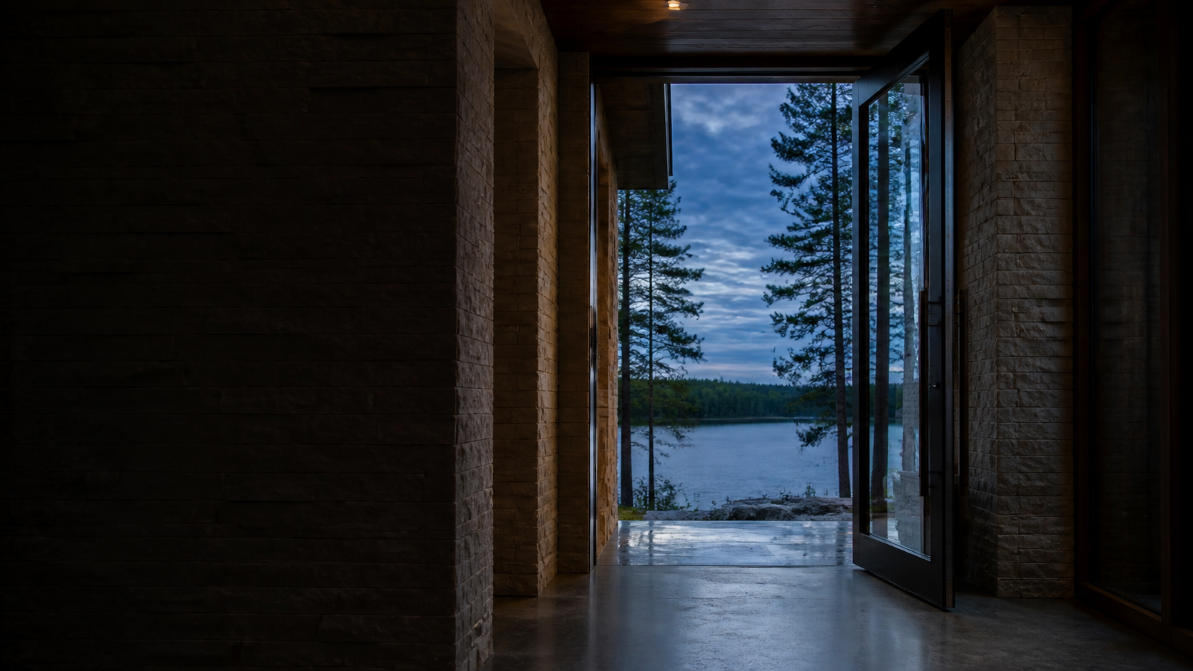 Open lake house entry framing a quiet Great Lakes view at blue hour
